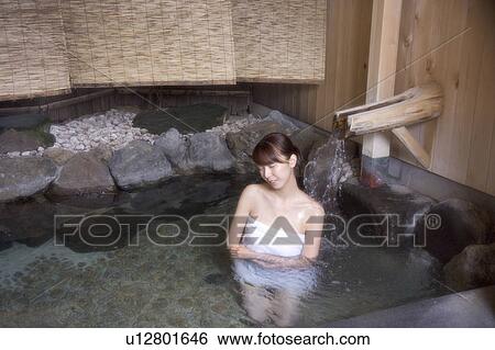 A young woman bathing in hot springs View Large Photo Image Stock Photograph - A young woman bathing in hot springs. Fotosearch