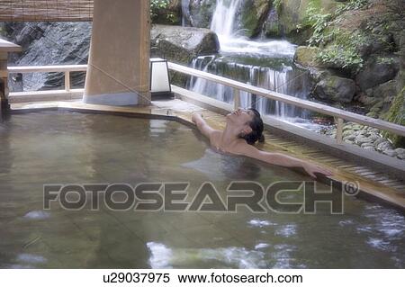 Stock Photography - A young woman bathing in hot springs. Fotosearch