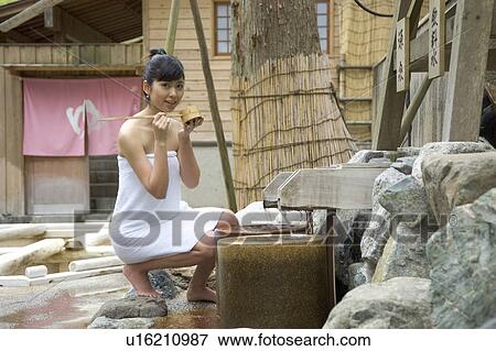 A Young woman drinking spring water View Large Photo Image Stock Photo - A Young woman drinking spring water. Fotosearch