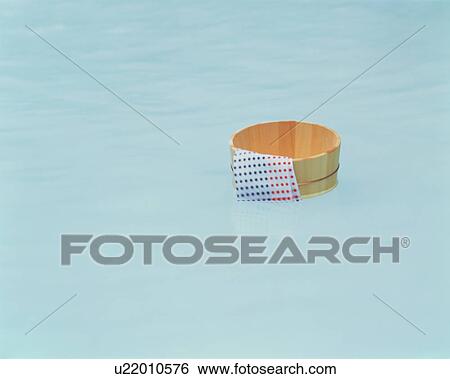 Stock Photograph - Bathing pail floating in hot springs in Japan. Fotosearch