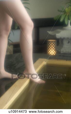Low section of a woman bathing in hot springs View Large Photo Image Stock Image - Low section of a woman bathing in hot springs. Fotosearch