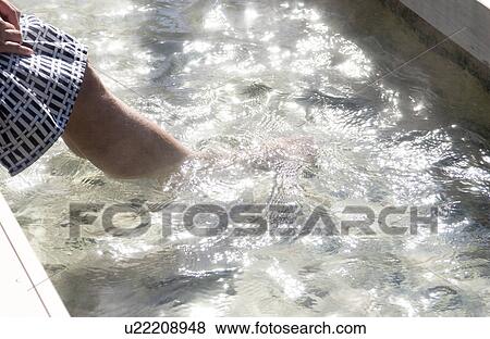 Stock Photo - Low section of a woman bathing in hot springs. Fotosearch