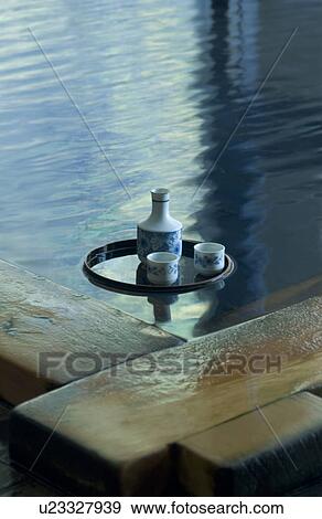 Sake bottle floating on hot water View Large Photo Image Stock Photo - Sake bottle floating on hot water. Fotosearch