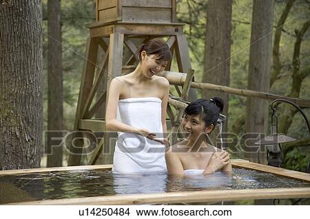 Two young women bathing in hot springs View Large Photo Image Picture - Two young women bathing in hot springs. Fotosearch