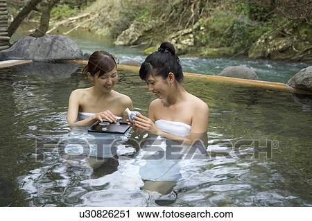 Two young women bathing in hot springs View Large Photo Image Stock Image - Two young women bathing in hot springs. Fotosearch