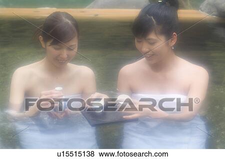 Two young women bathing in hot springs View Large Photo Image Stock Photo - Two young women bathing in hot springs. Fotosearch