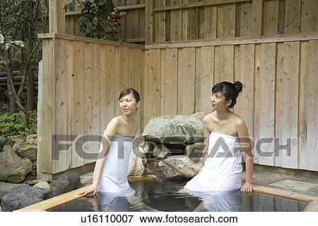 Stock Photo - Two young women bathing in hot springs. Fotosearch