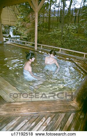 Stock Photo - Two young women bathing in hot springs. Fotosearch