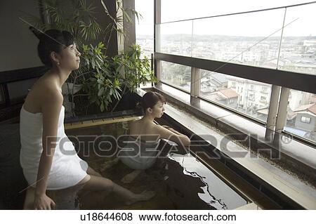 Stock Photo - Two young women bathing in hot springs. Fotosearch