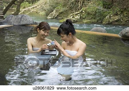 Stock Photo - Two young women bathing in hot springs. Fotosearch
