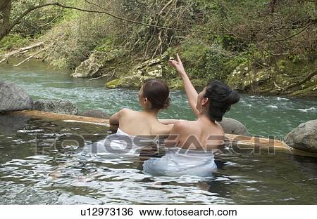 Two young women bathing in hot springs View Large Photo Image Stock Photograph - Two young women bathing in hot springs. Fotosearch