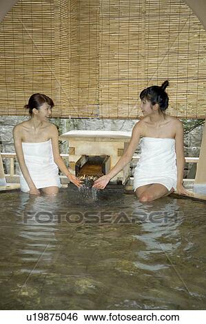 Two Young Women Bathing In Hot Springs Stock Photograph U Fotosearch