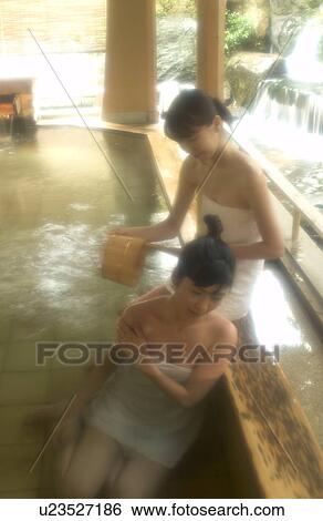 Stock Photograph - Two young women bathing in hot springs. Fotosearch
