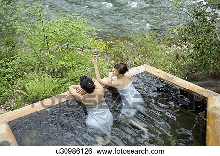 Stock Photograph - Two young women bathing in hot springs. Fotosearch