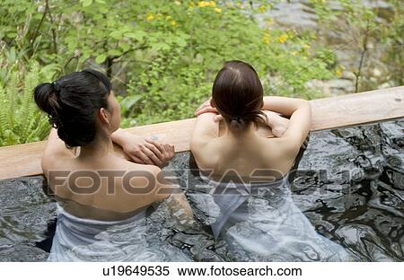Stock Photography - Two young women bathing in hot springs. Fotosearch