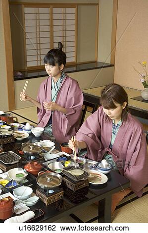 Two young women eating dinner in Japanese style inn View Large Photo Image Stock Image - Two young women eating dinner in Japanese style inn. Fotosearch