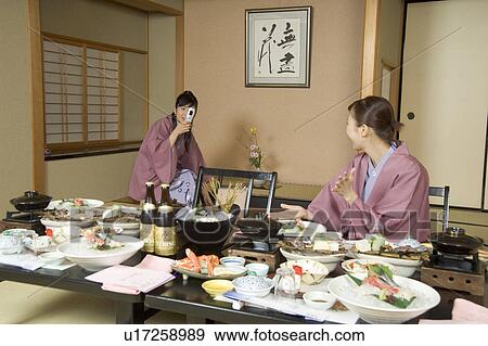 Two young women eating dinner in Japanese style inn View Large Photo Image Stock Photo - Two young women eating dinner in Japanese style inn. Fotosearch