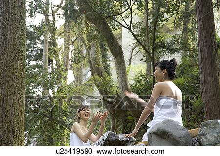 Two young women playing in hot springs View Large Photo Image Stock Image - Two young women playing in hot springs. Fotosearch