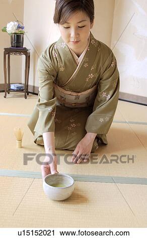 A woman in kimono serving a cup of green tea View Large Photo Image Stock Image - A woman in kimono serving a cup of green tea. Fotosearch