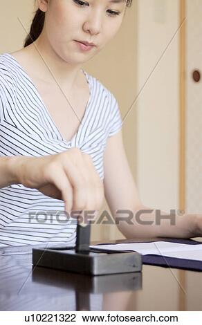 Stock Image - A woman preparing ink brush writing. Fotosearch
