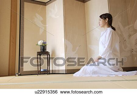 Stock Photograph - A woman sitting in calm. Fotosearch