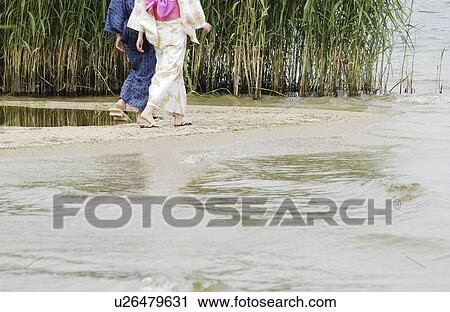 A young couple in kimono walking on lake side View Large Photo Image Stock Image - A young couple in kimono walking on lake side. Fotosearch