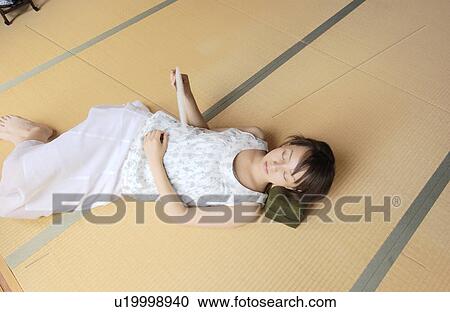 A young woman taking a nap in tatami room View Large Photo Image Stock Image - A young woman taking a nap in tatami room. Fotosearch