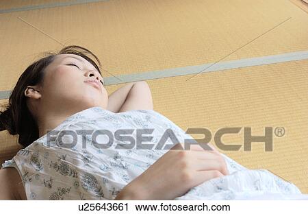 A young woman taking a nap in tatami room View Large Photo Image Stock Image - A young woman taking a nap in tatami room. Fotosearch