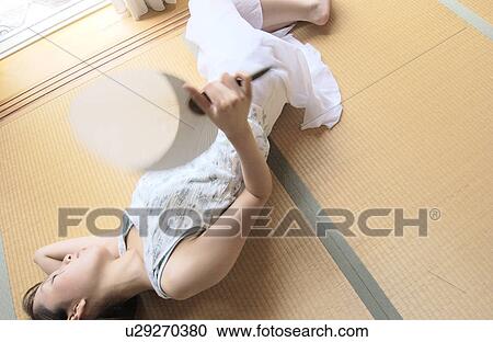 A young woman taking a nap in tatami room with fan, blurred motion View Large Photo Image Stock Image - A young woman taking a nap in tatami room with fan, blurred motion. Fotosearch