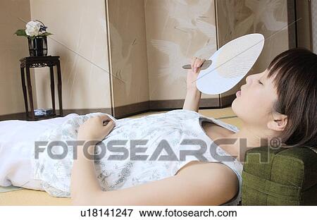 Stock Photo - A young woman taking a nap. Fotosearch