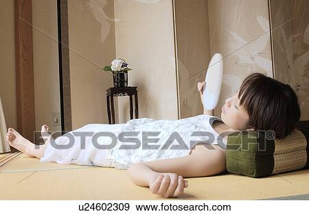 Stock Photo - A young woman taking a nap. Fotosearch