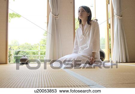Stock Image - Portrait of a woman sitting. Fotosearch