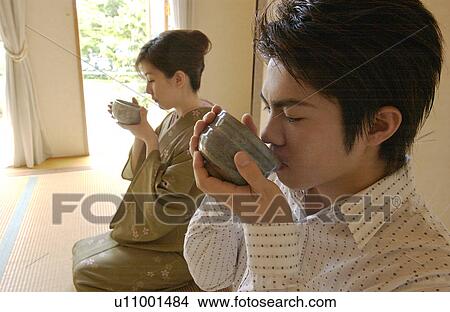 Two people drinking a cup of green tea View Large Photo Image Picture - Two people drinking a cup of green tea. Fotosearch