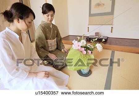 Stock Photo - Two women arranging flowers. Fotosearch