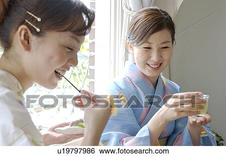 Stock Photograph - Two women drinking green tea. Fotosearch