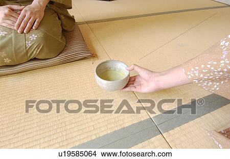 Picture - Two women in kimono attending tea ceremony. Fotosearch
