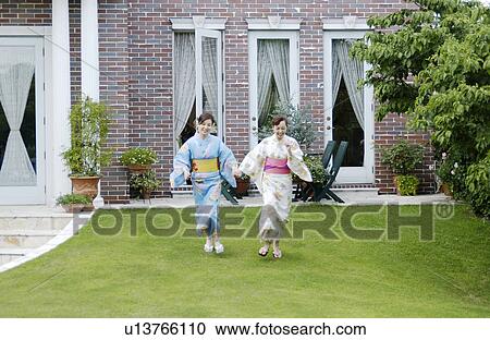 Two women in kimono running View Large Photo Image Stock Image - Two women in kimono running. Fotosearch