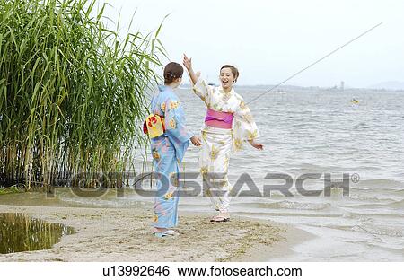 Two young women in kimono playing on lake side View Large Photo Image Stock Photograph - Two young women in kimono playing on lake side. Fotosearch