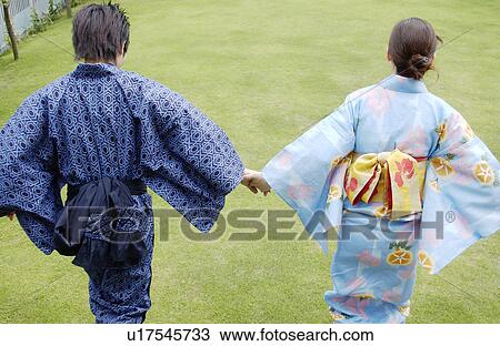 Young couple in kimono holding hands View Large Photo Image Stock Image - Young couple in kimono holding hands. Fotosearch