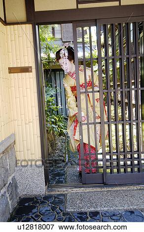A Geisha woman opening a door View Large Photo Image Stock Photo - A Geisha woman opening a door. Fotosearch