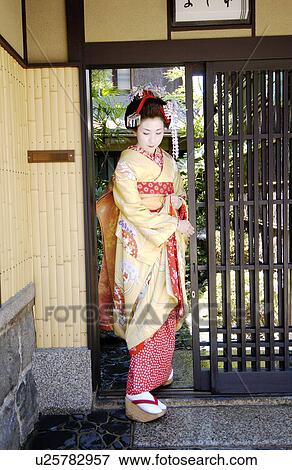 A Geisha woman opening a door View Large Photo Image Stock Photo - A Geisha woman opening a door. Fotosearch