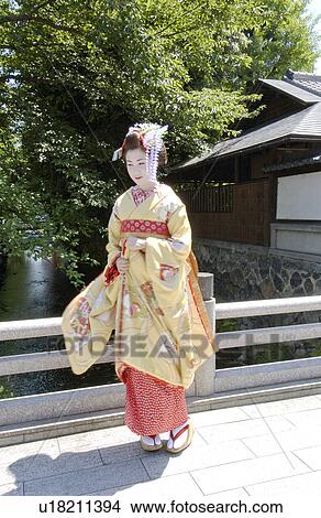 A Geisha woman standing by a river View Large Photo Image Picture - A Geisha woman standing by a river. Fotosearch