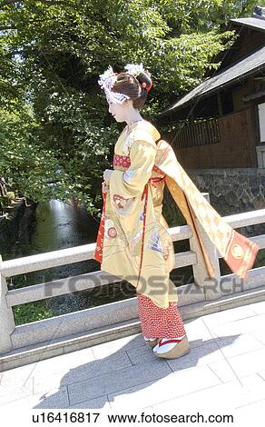 Stock Photo - A Geisha woman standing by a river. Fotosearch