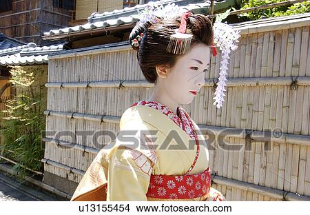 A Geisha woman walking on a street View Large Photo Image Picture - A Geisha woman walking on a street. Fotosearch