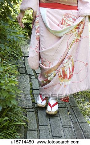 A Geisha woman walking on a street View Large Photo Image Stock Image - A Geisha woman walking on a street. Fotosearch