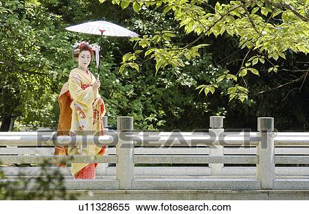 Portrait of a Geisha woman holding umbrella View Large Photo Image Stock Photography - Portrait of a Geisha woman holding umbrella. Fotosearch