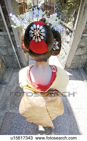 Rear view of a Geisha woman walking on a street View Large Photo Image Stock Image - Rear view of a Geisha woman walking on a street. Fotosearch