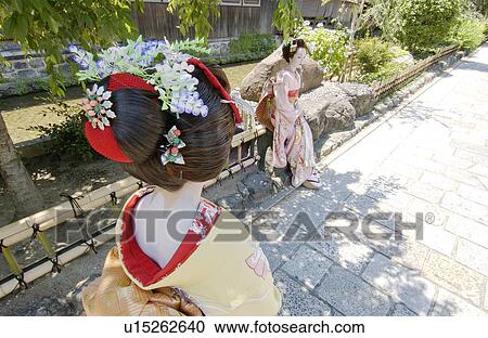 Stock Image - Rear view of a Geisha woman walking. Fotosearch