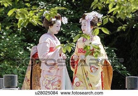Two geisha women talking View Large Photo Image Picture - Two geisha women talking . Fotosearch