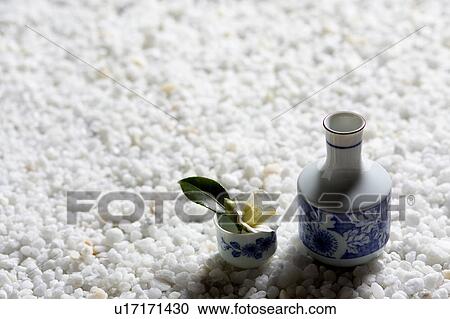 Stock Image - Camellia in a sake cup. Fotosearch